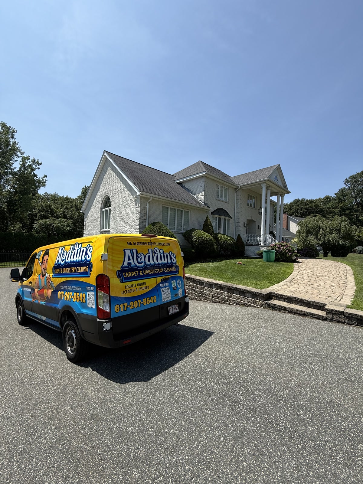 Aladdin’s truck at the rear quarter of a colonial-style stone home