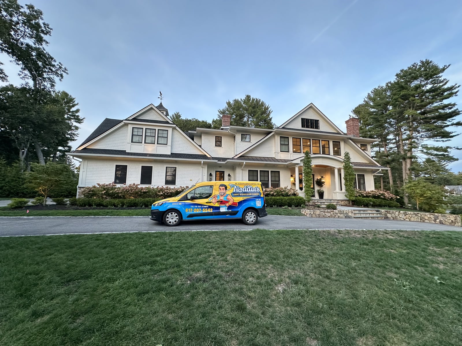 Aladdin’s van parked along a long driveway in front of a large white shingle home